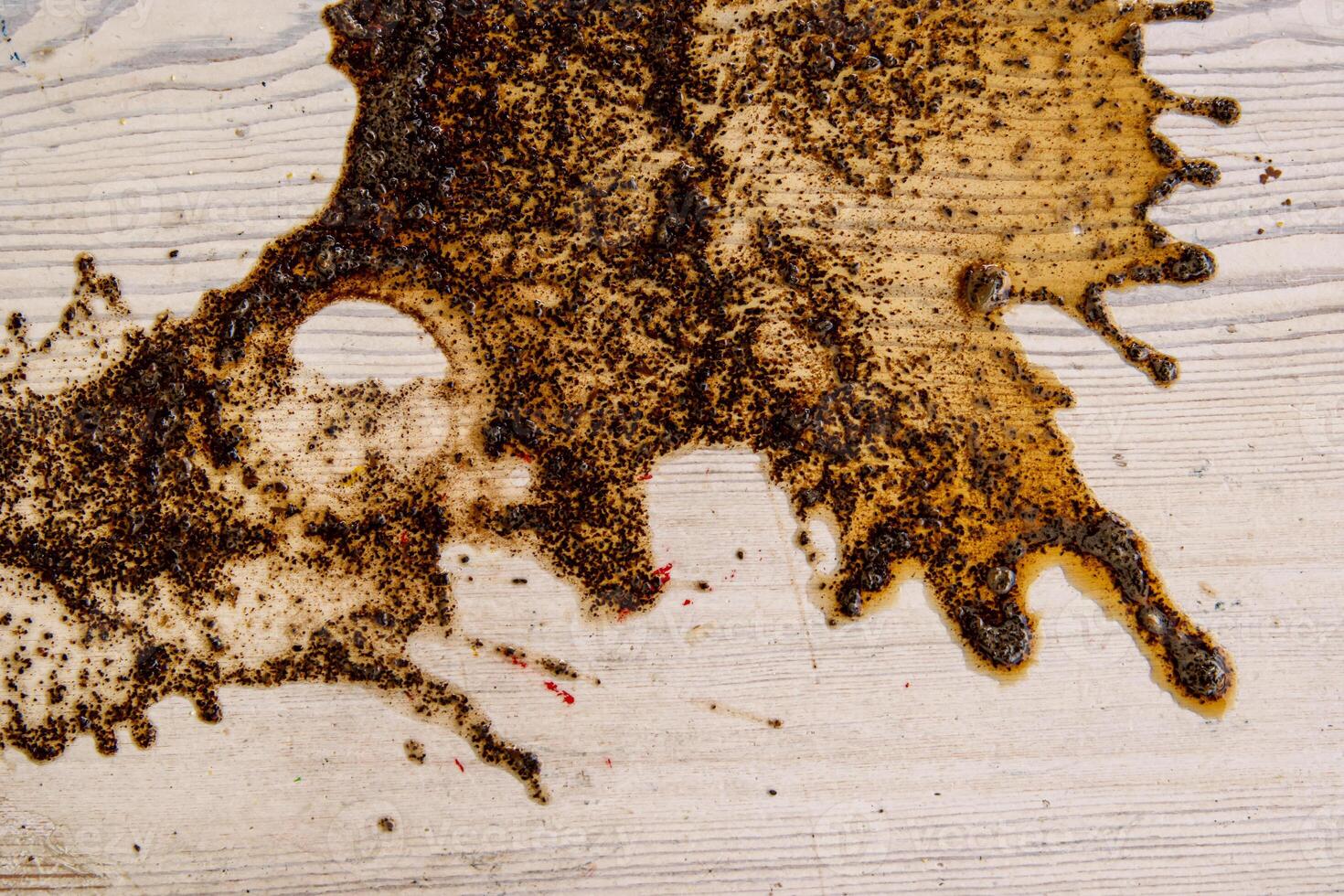 Coffee stains on white wooden table. Wood texture background. Big dark brown dramatic Splatter, fleck, splash, spot, drops of black coffee. Pattern, wallpaper. Top view. Closeup. Copy space. photo