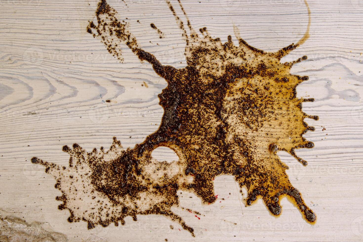 Coffee stains on white wooden table. Wood texture background. Big dark brown dramatic Splatter, fleck, splash, spot, drops of black coffee. Pattern, wallpaper. Top view. Closeup. Copy space. photo