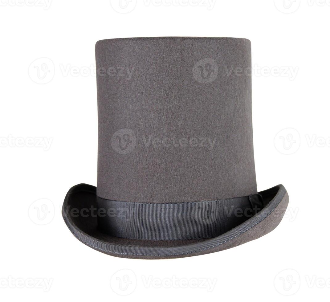 Magic hat. Topper. Elegant vintage gray beige wool felt top hat with black band on the wooden hat block. Grosgrain ribbon trim around rolled brim. Isolated on white background. Close-up. Copy space. photo