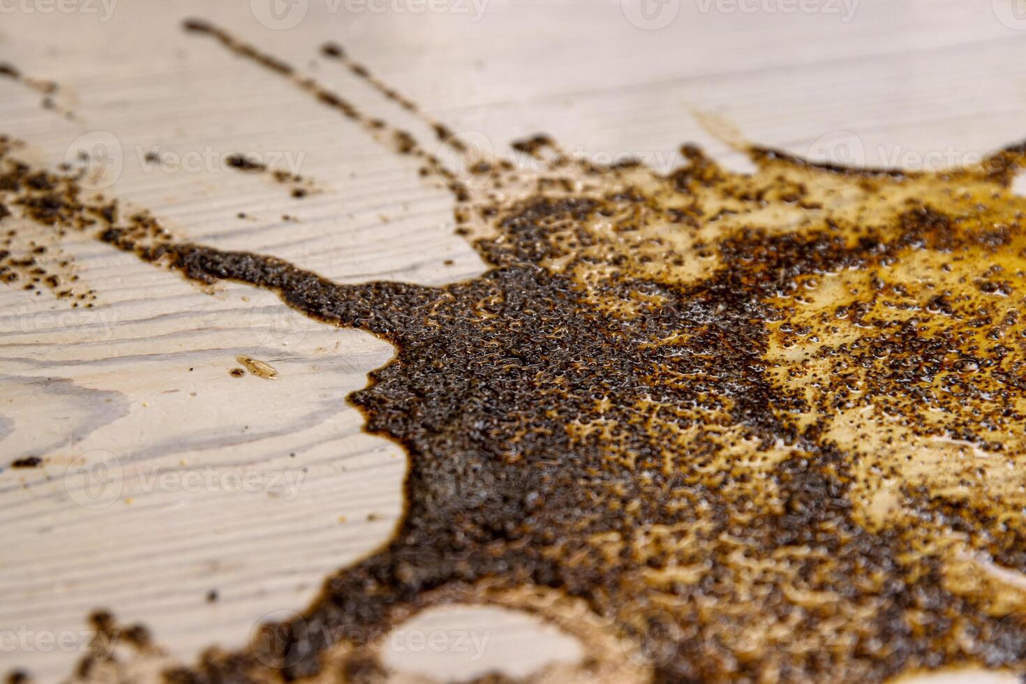 Coffee stains on white wooden table. Wood texture background. Big dark brown dramatic Splatter, fleck, splash, spot, drops of black coffee. Pattern, wallpaper. Top view. Closeup. Copy space. photo