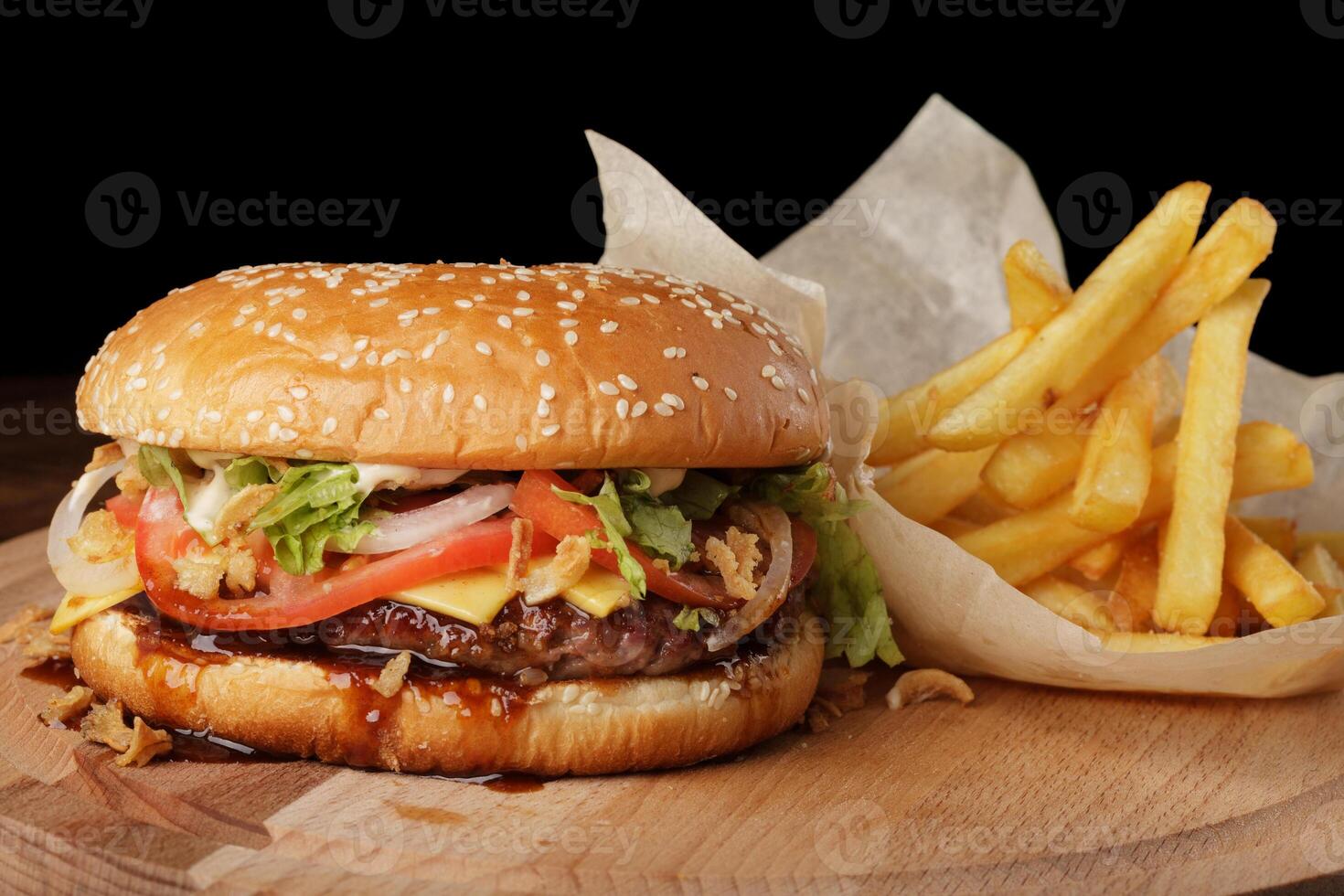 Cheeseburger with french fries and sauce. photo