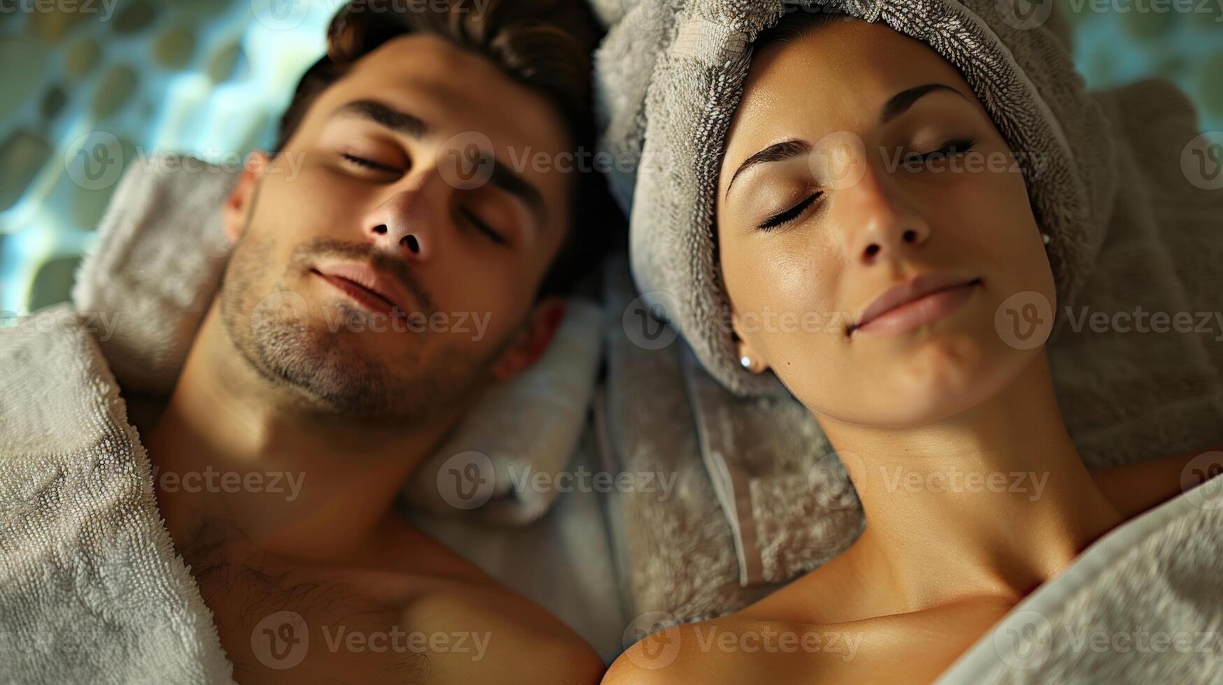 A couple enjoying a relaxing couples massage dd in plush spa robes and swathed in soft spa towels. photo