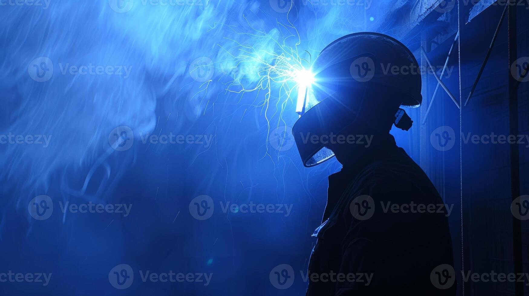 The intense bluewhite light from the welding torch casts a mesmerizing glow around the workers helmet photo