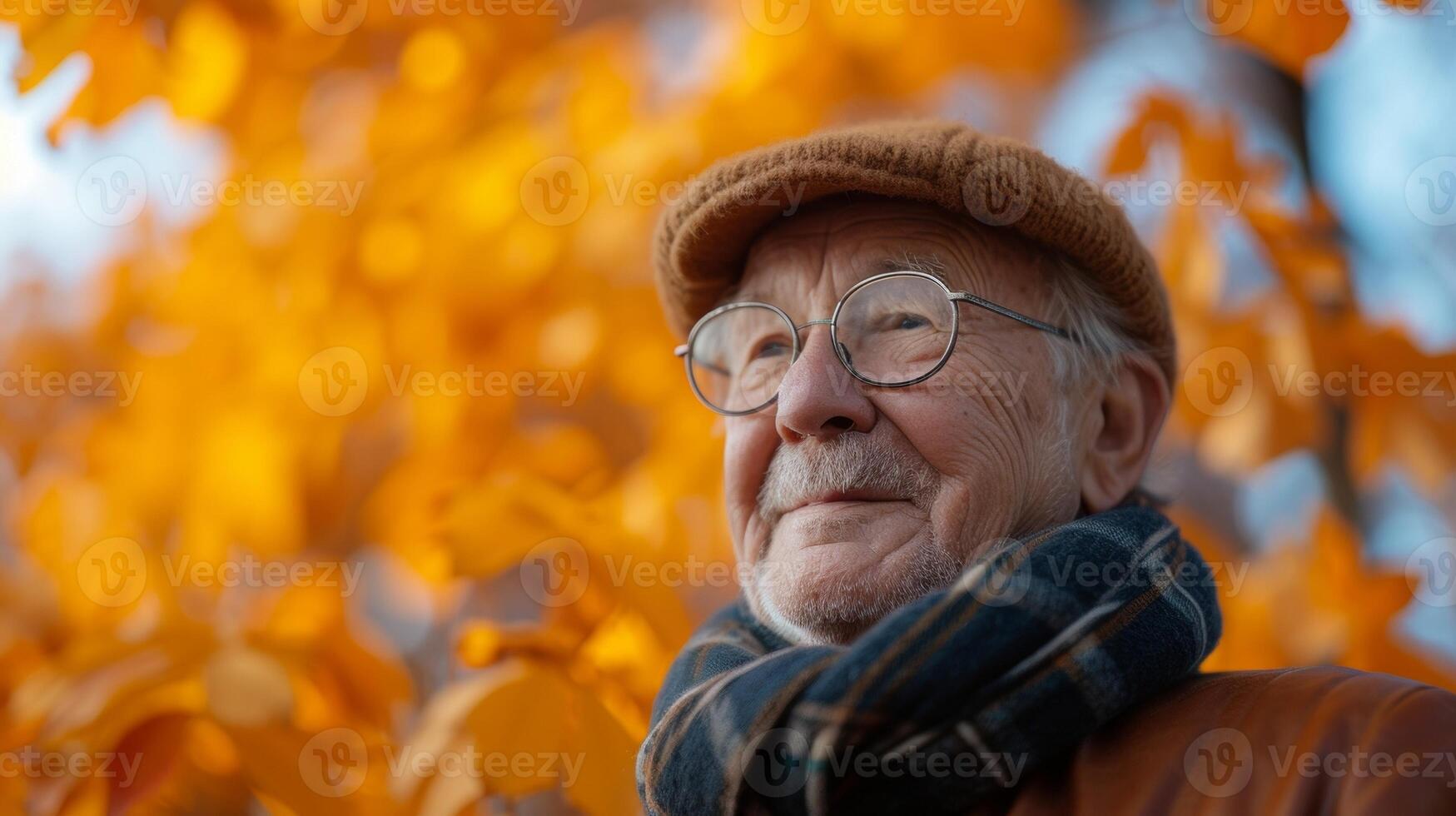 As the leaves change colors an elderly man enjoys the autumn weather while replying to customer inquiries for his passive income venture photo