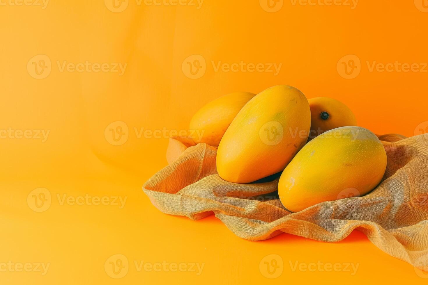 ripe mangoes on linen isolated on an orange gradient background photo
