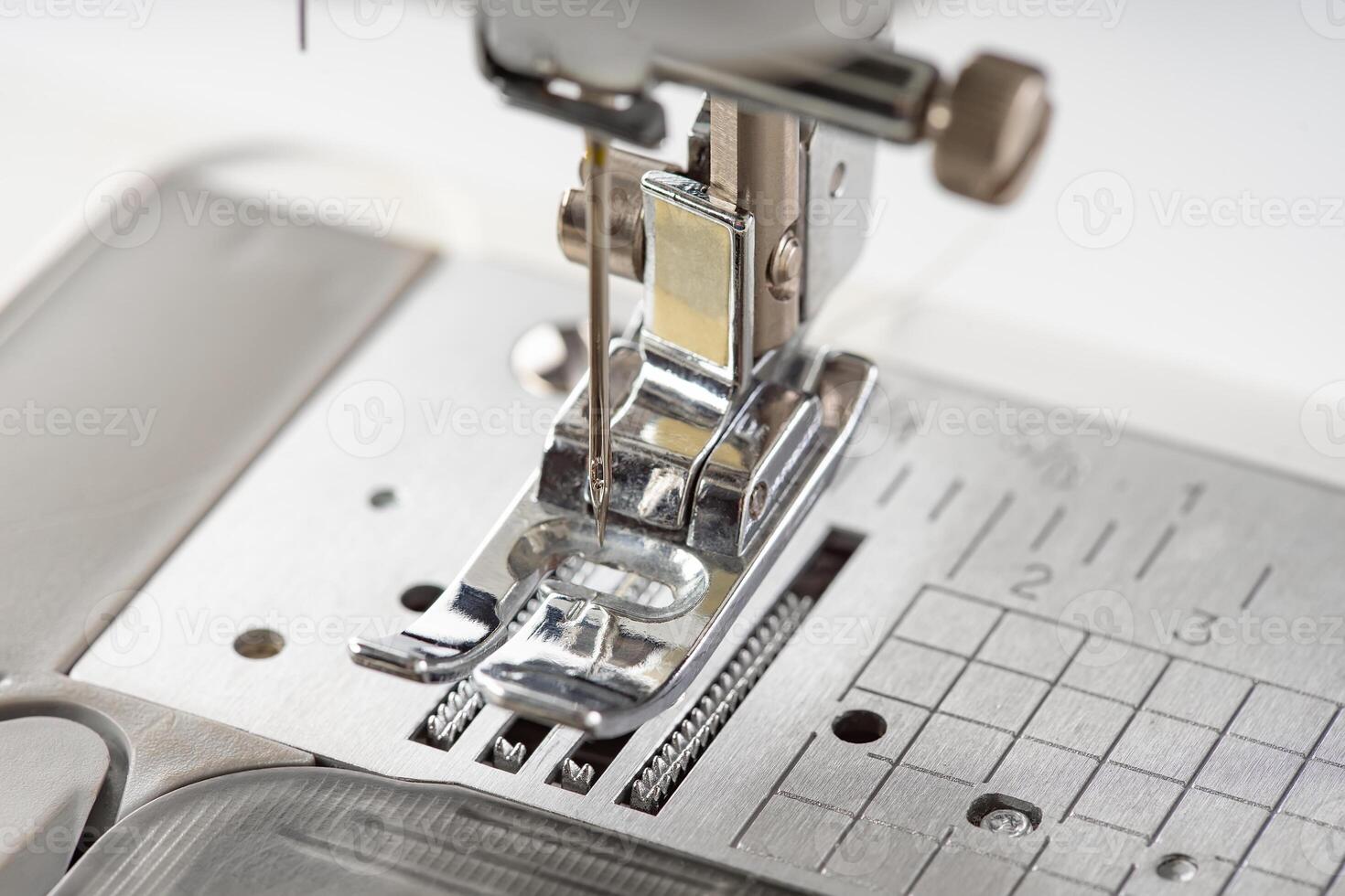 Modern sewing machine presser foot closeup, macro photo