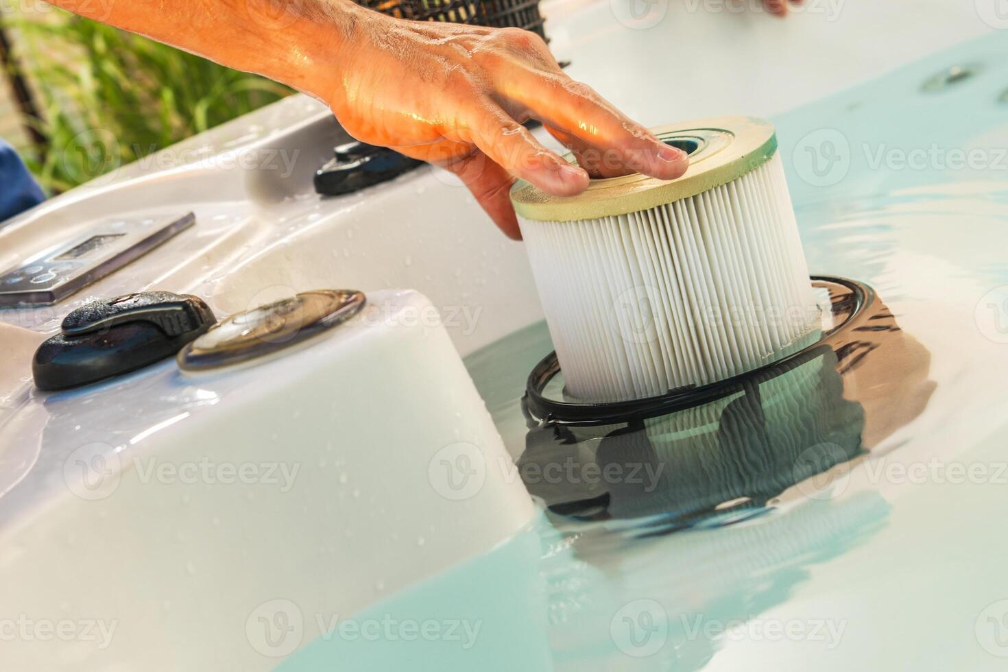 Man Removing Dirty Hot Tub Filter photo