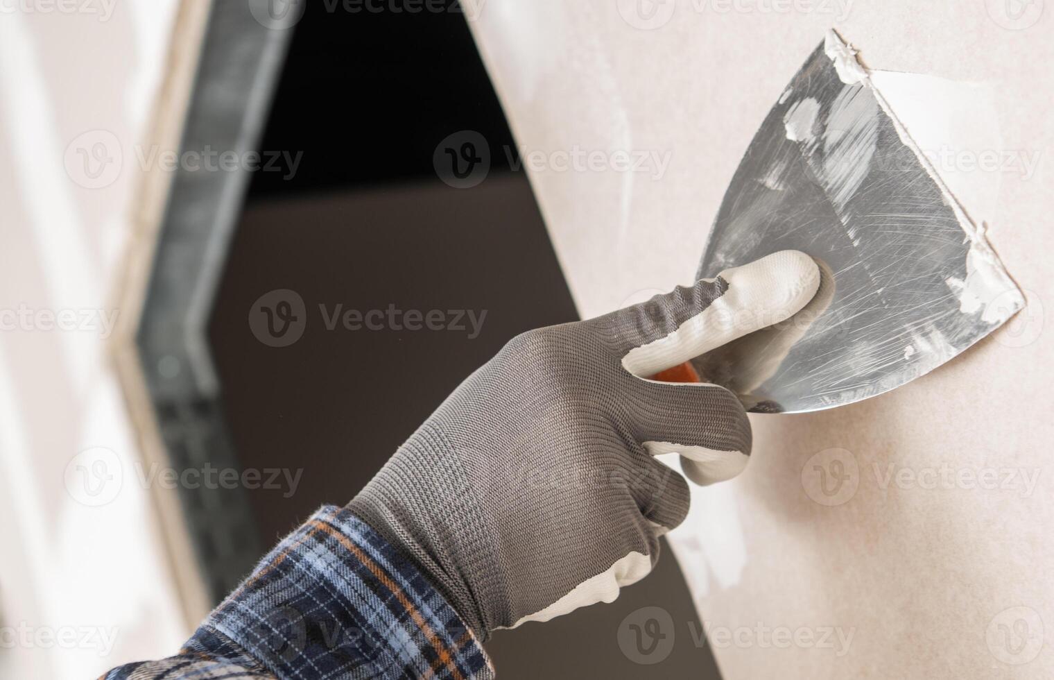 Construction Site Worker Patching a Wall photo