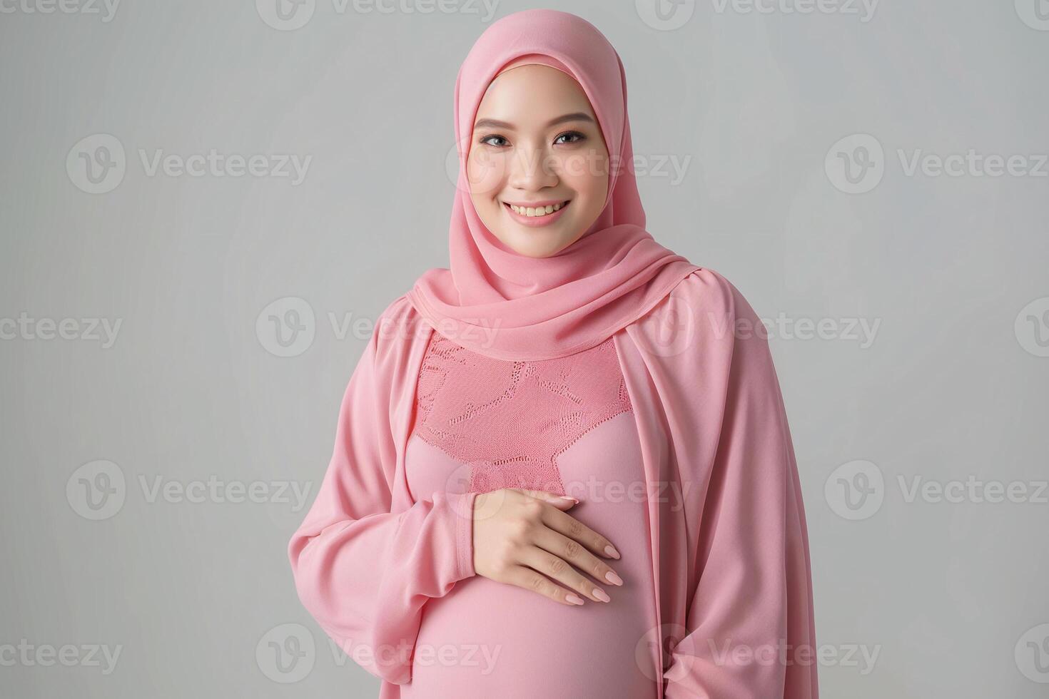 Radiant Expectant Mother in Soft Pink Hijab Embracing Motherhood photo