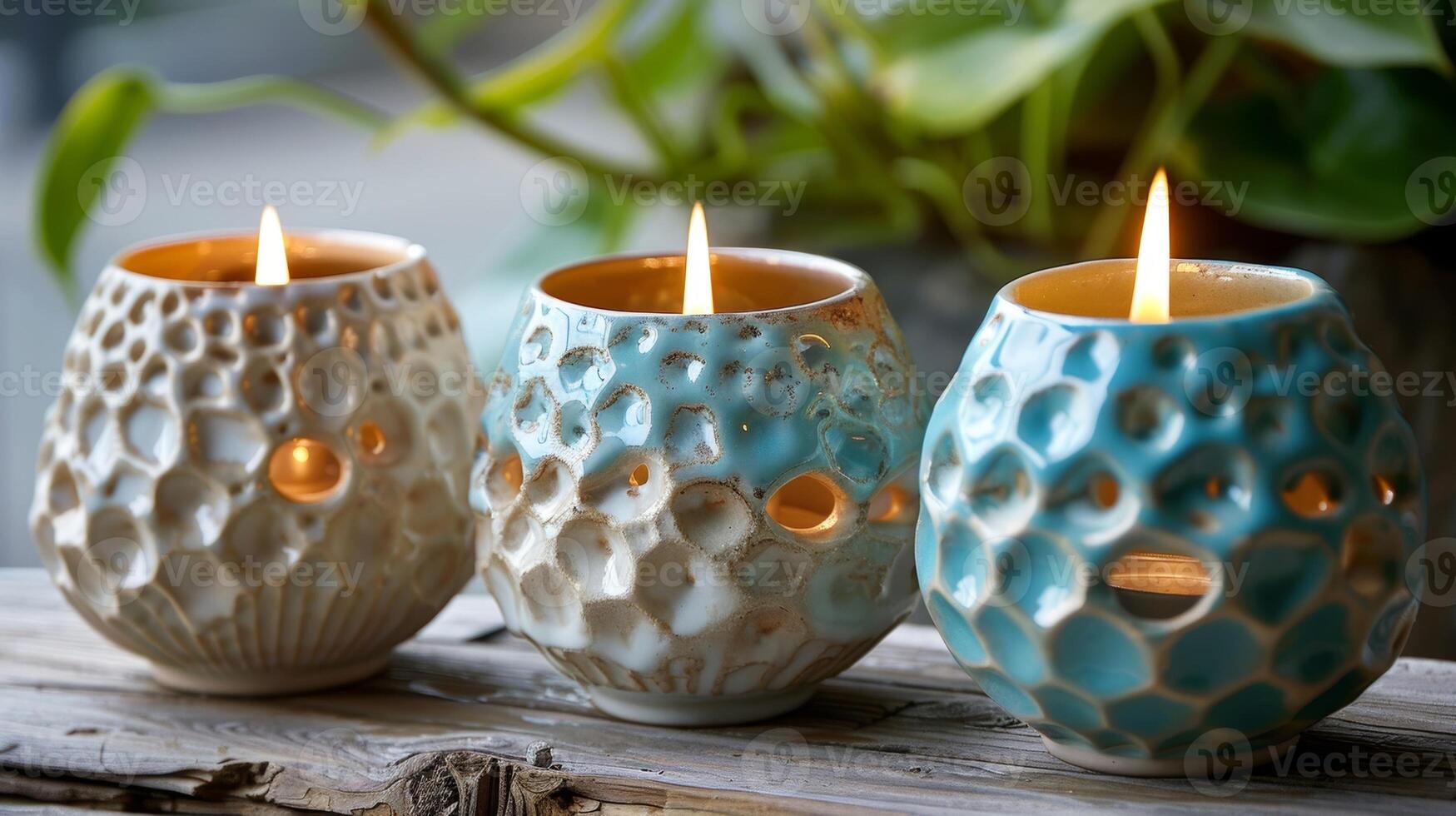 A trio of ceramic tealight candle holders with a glossy finish and a bumpy texture reminiscent of barnacle shells. photo