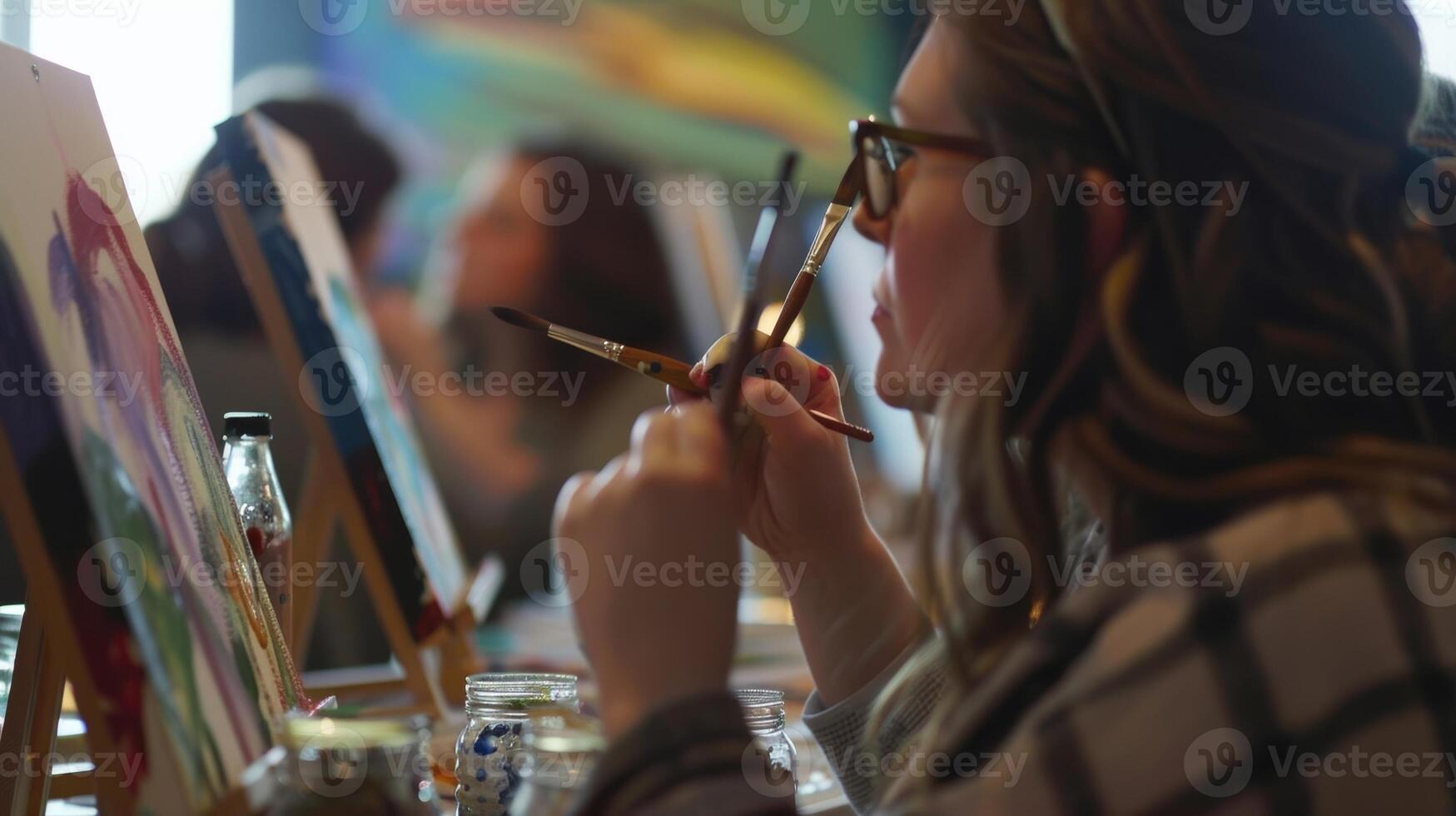 A glimpse into the fun and relaxed atmosphere of a sober paint and sip as participants take a break to share stories and jokes while sipping on their creative concoctions photo