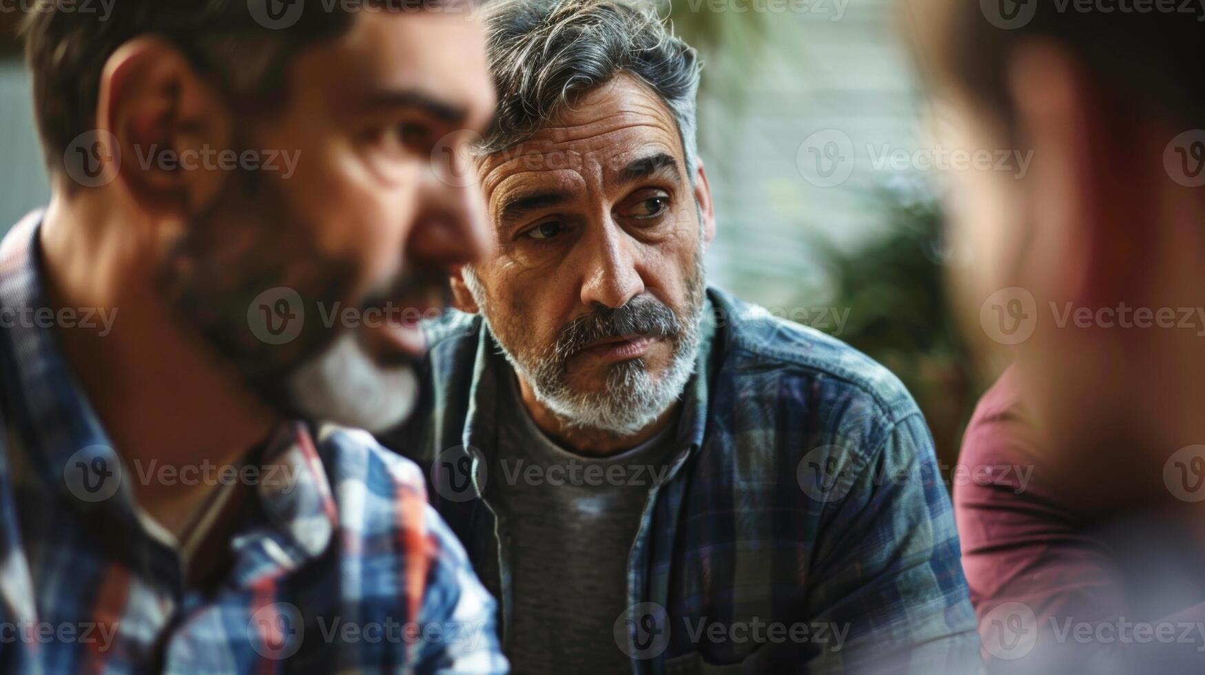 A group of men showing vulnerability and expressing their emotions openly at a male support group gathering photo