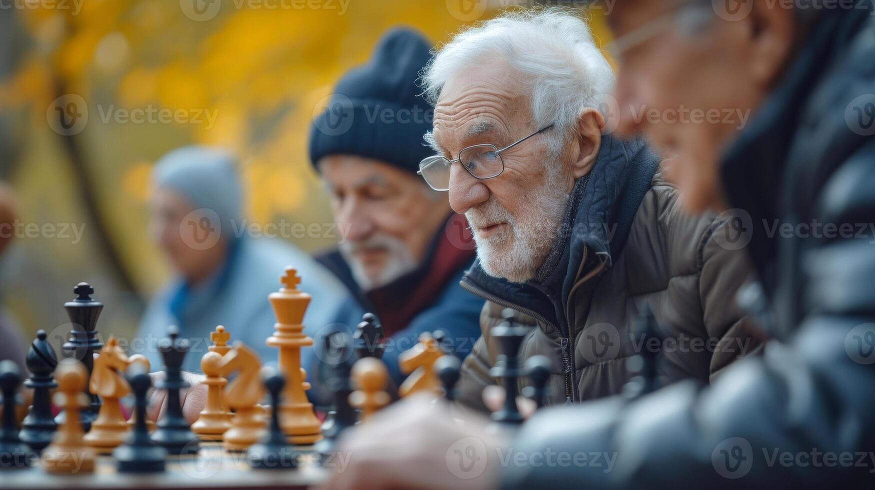 Amidst the lush greenery of the park a group of seniors huddle around a chess board their determined expressions reflecting the intensity of the game photo
