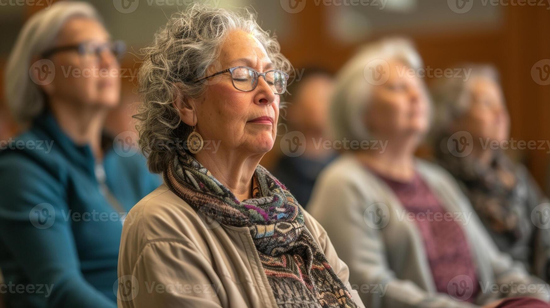 Soft music plays in the background as retirees of various backgrounds and ages participate in a mindfulness workshop guided by an experienced instructor photo