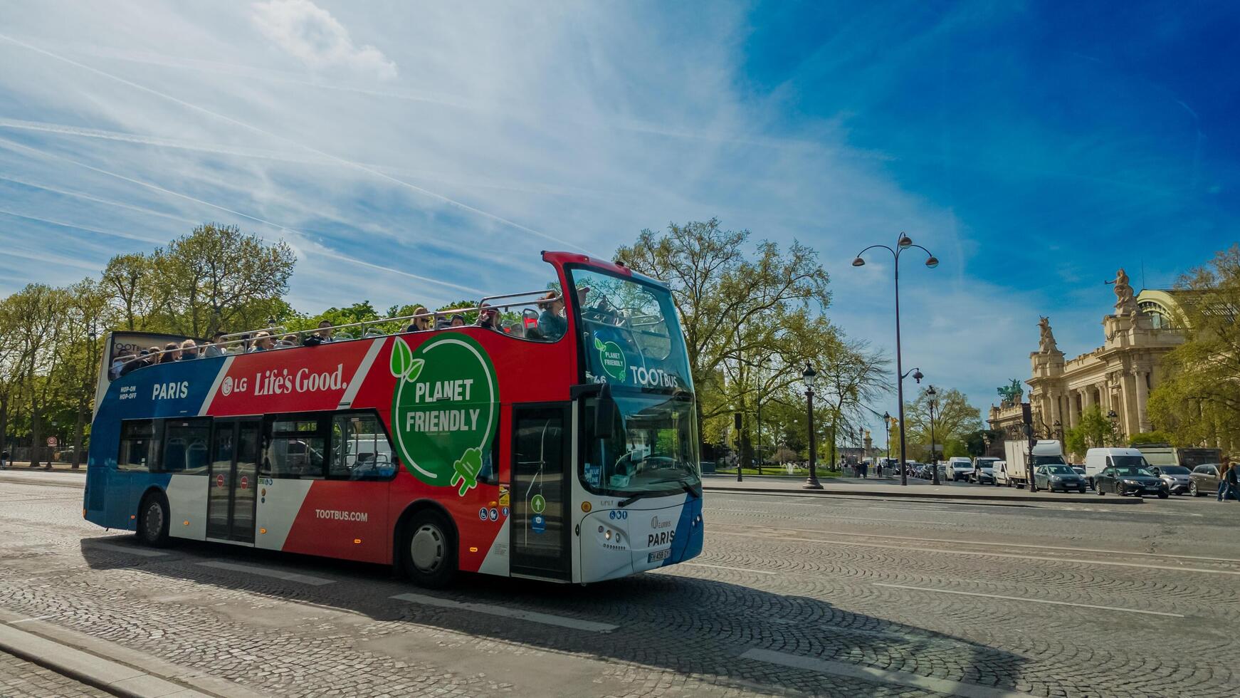 Open top eco friendly tour bus on a sunny day in Paris, promoting sustainable travel, ideal for Earth Day and environmentally focused initiatives photo