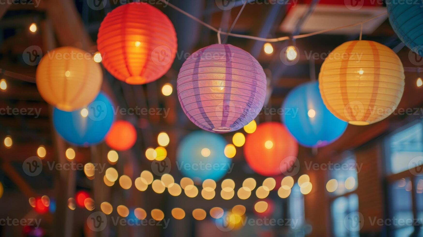 Colorful paper lanterns and string lights hang from the ceiling adding a whimsical touch to the space photo