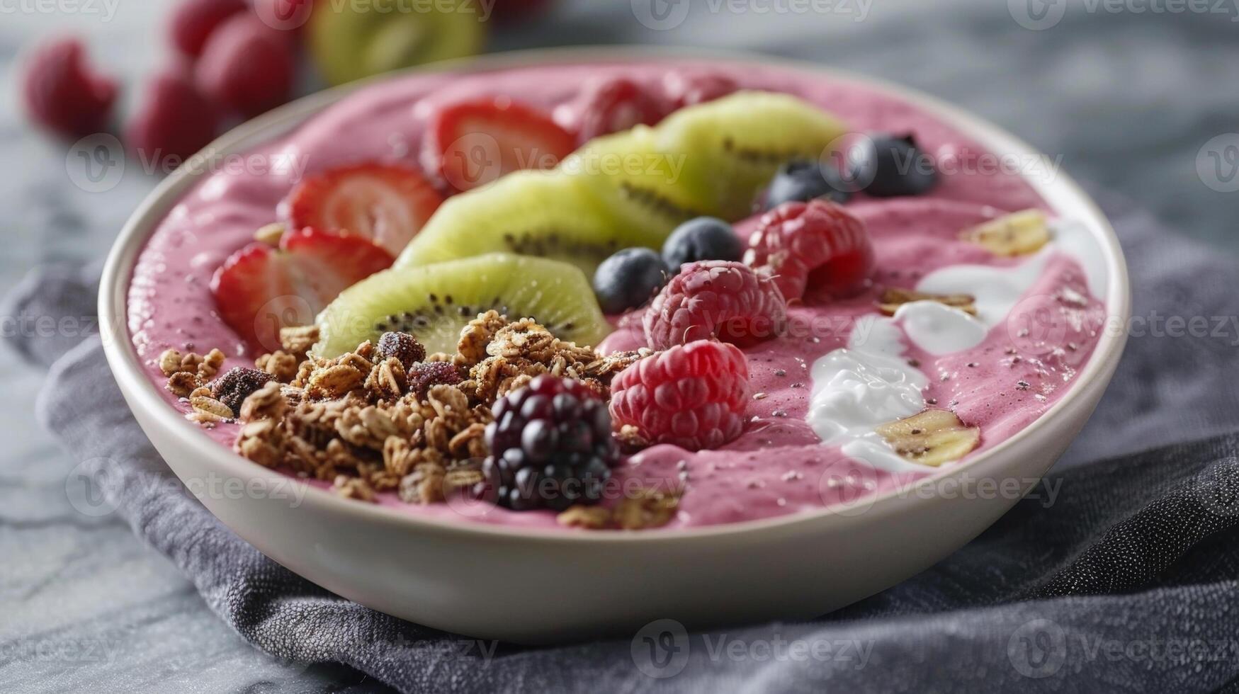 A tropical fruit smoothie bowl topped with granola sliced fruits and a dollop of creamy coconut yogurt photo