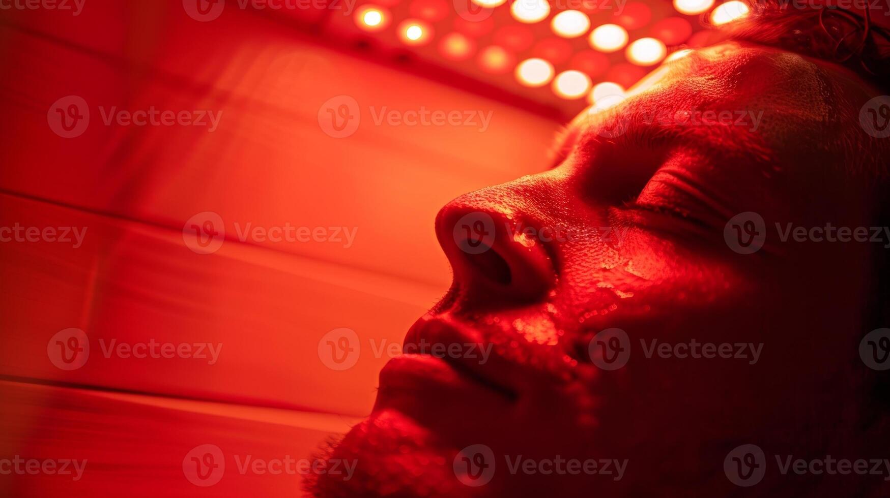 A person using red light therapy in the sauna harnessing the power of light to improve cellular functioning and promote healing. photo