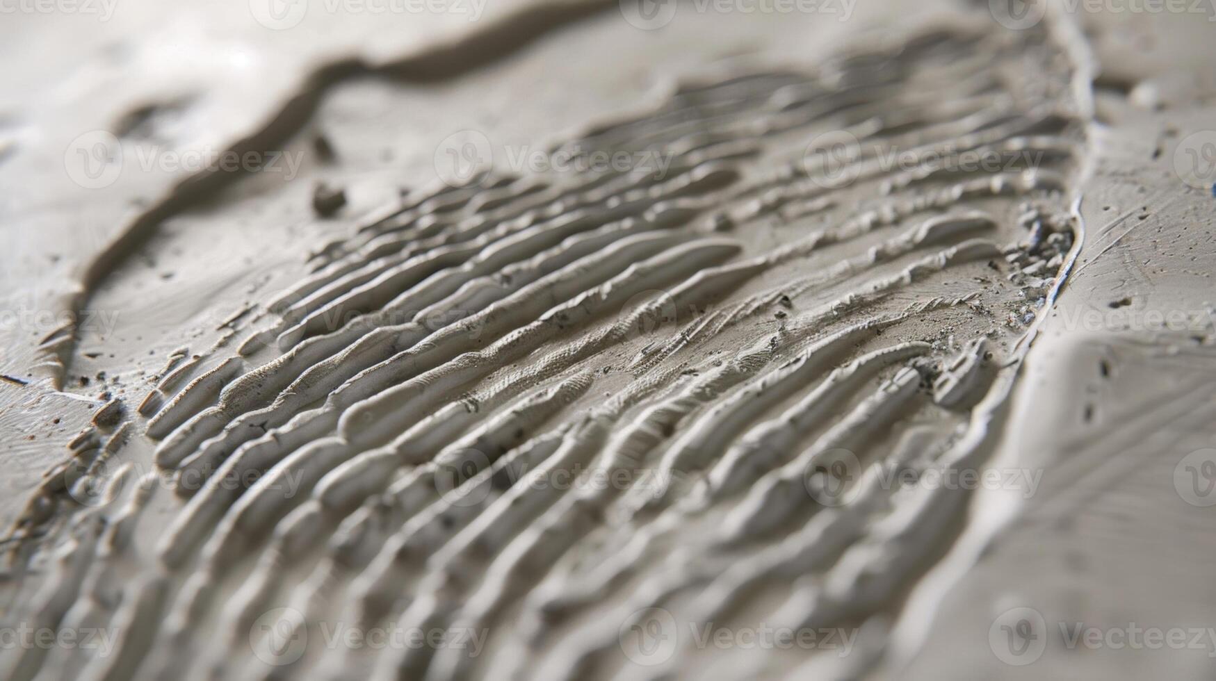 The intricate pattern of a persons fingerprints left on a piece of unfired clay adding a personal and human touch to the artwork. photo