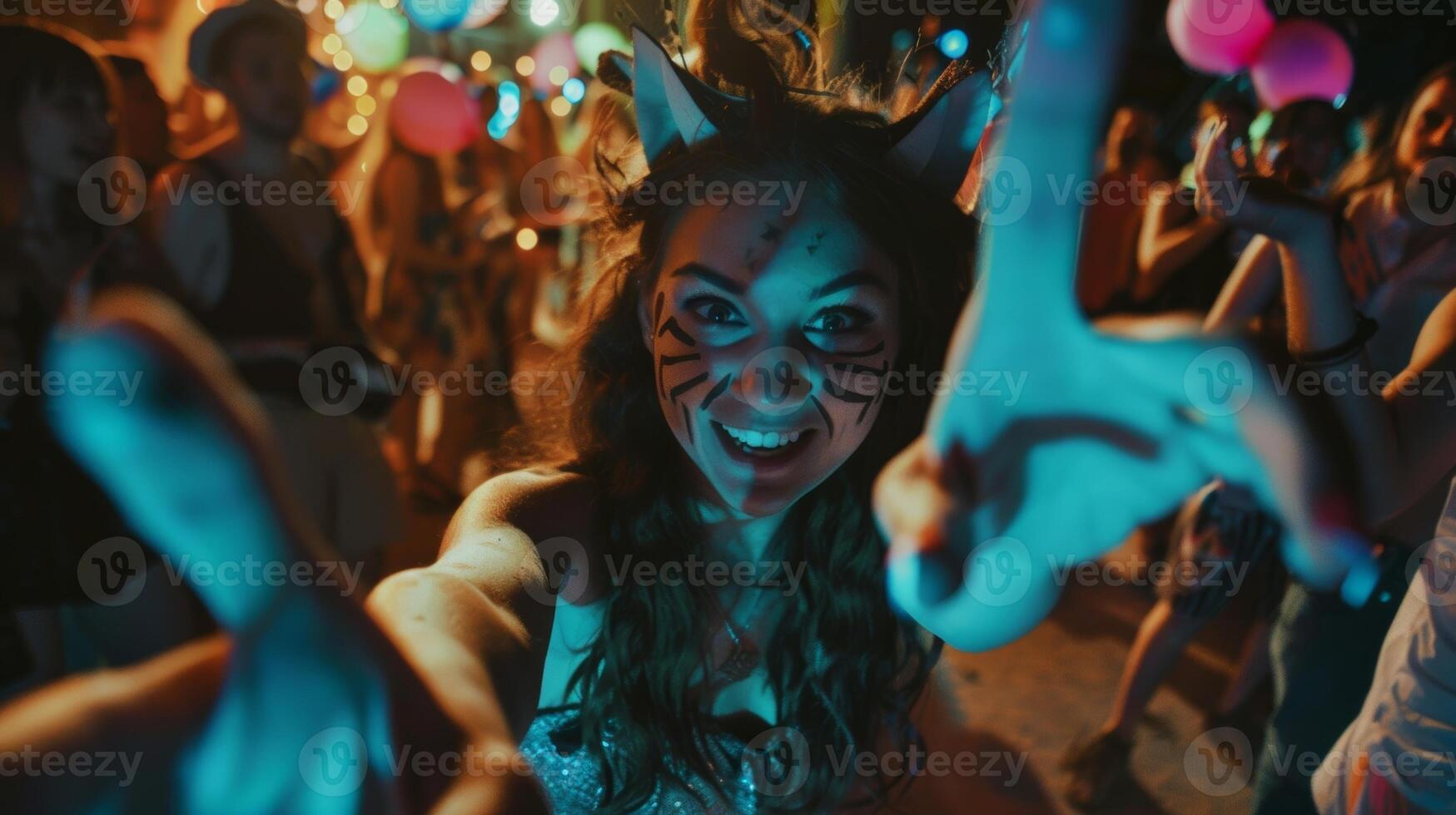 A woman dressed as a cat slinks through the crowd her claws made out of painted popsicle sticks photo