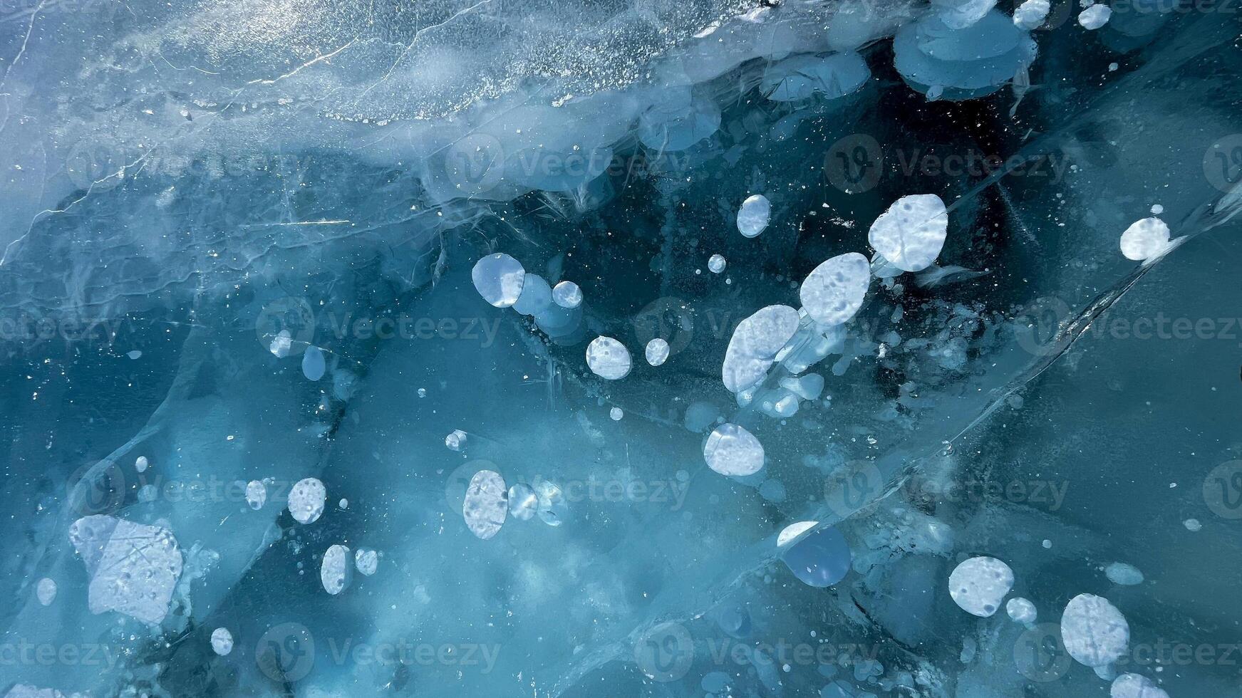 Abstract air bubbles frozen on the ice surface of Lake Baikal in Siberia. photo