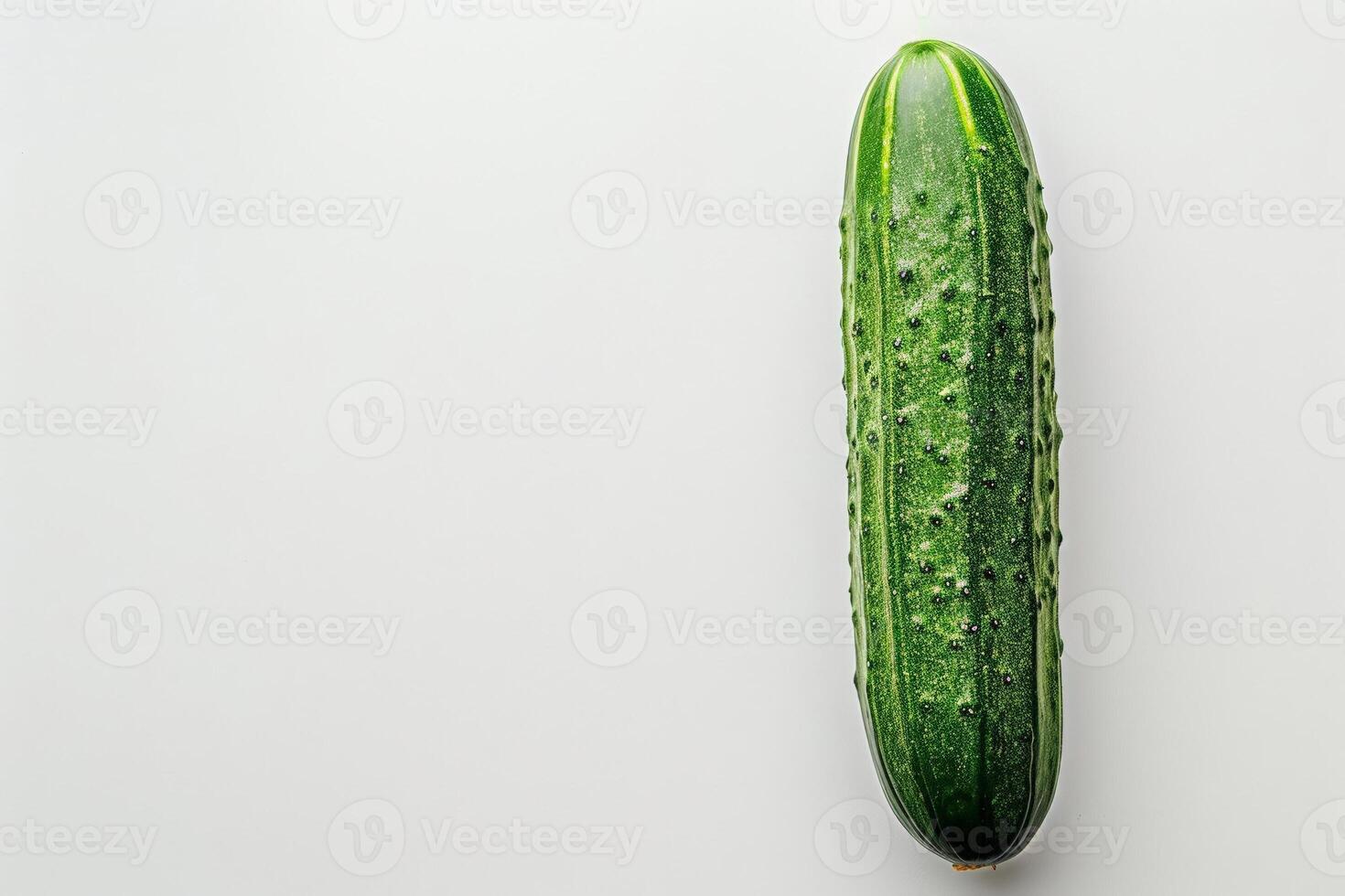 Single ripe cucumber isolated on a white background, perfect for a minimalist design photo