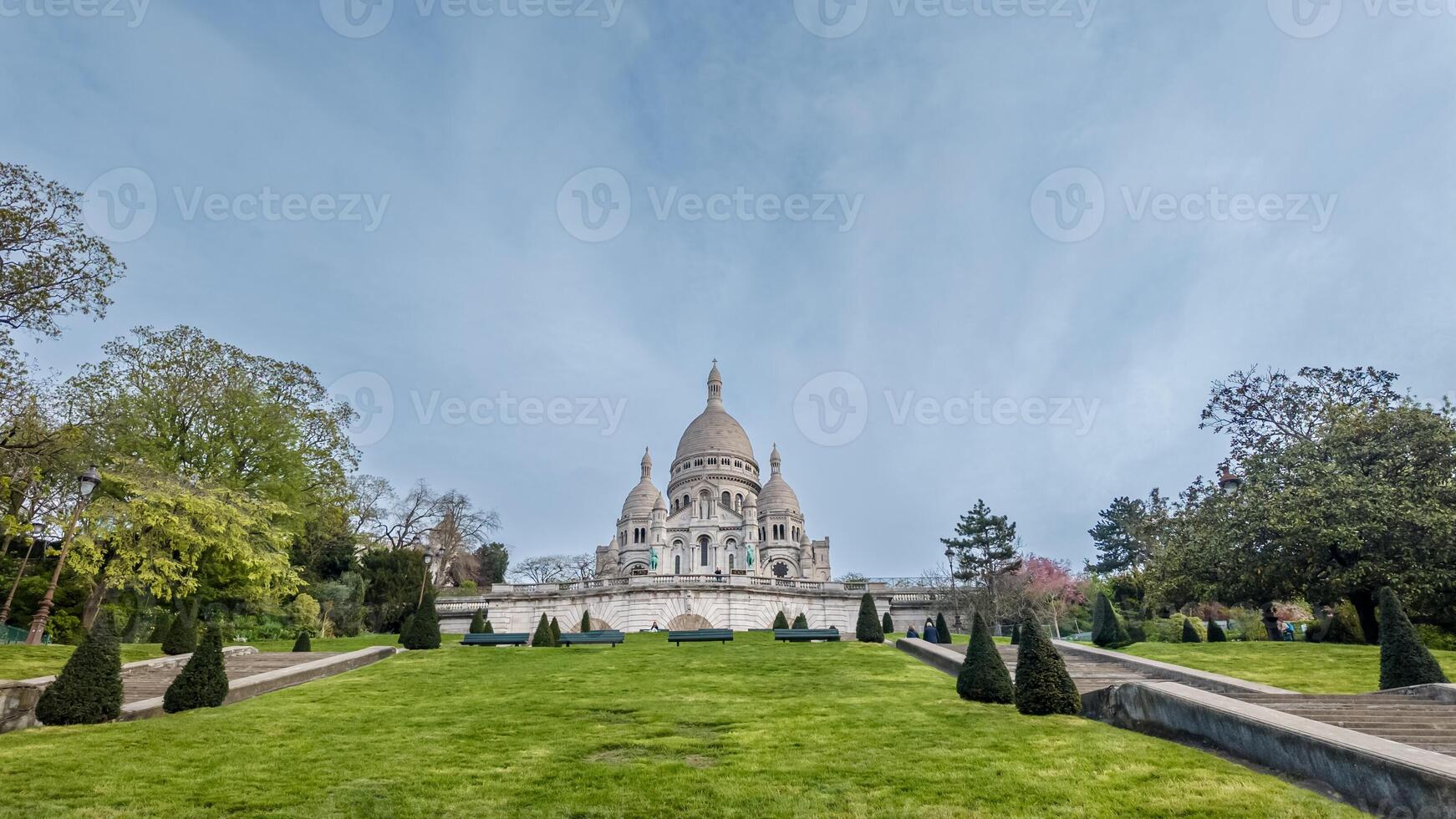 Sunny day at the iconic Basilica of the Sacred Heart in Montmartre, Paris, ideal for travel tourism and European heritage concepts photo