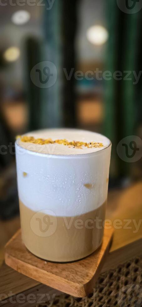 Fresh iced coffee in glass with frothy cream for your design, Food concept in style, copy space photo