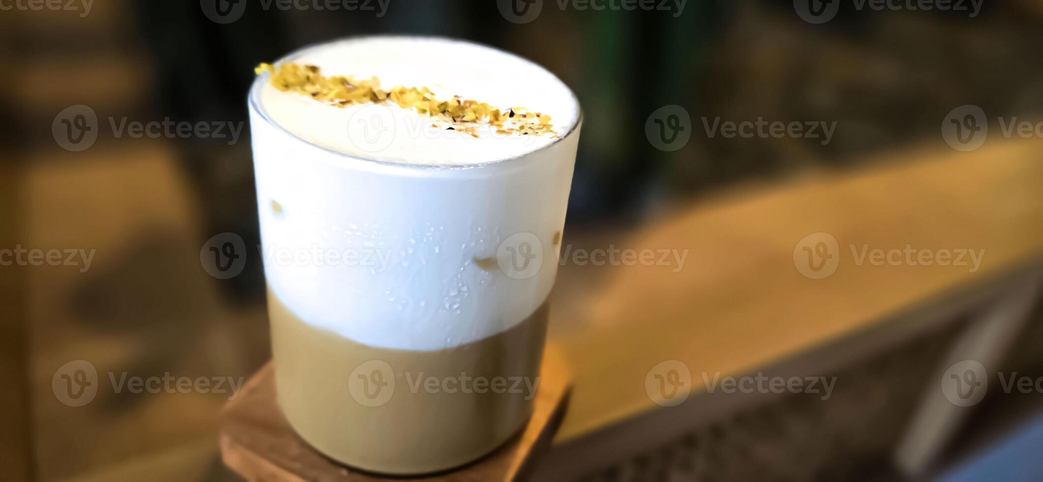 Fresh iced coffee in glass with frothy cream for your design, Food concept in style, copy space photo