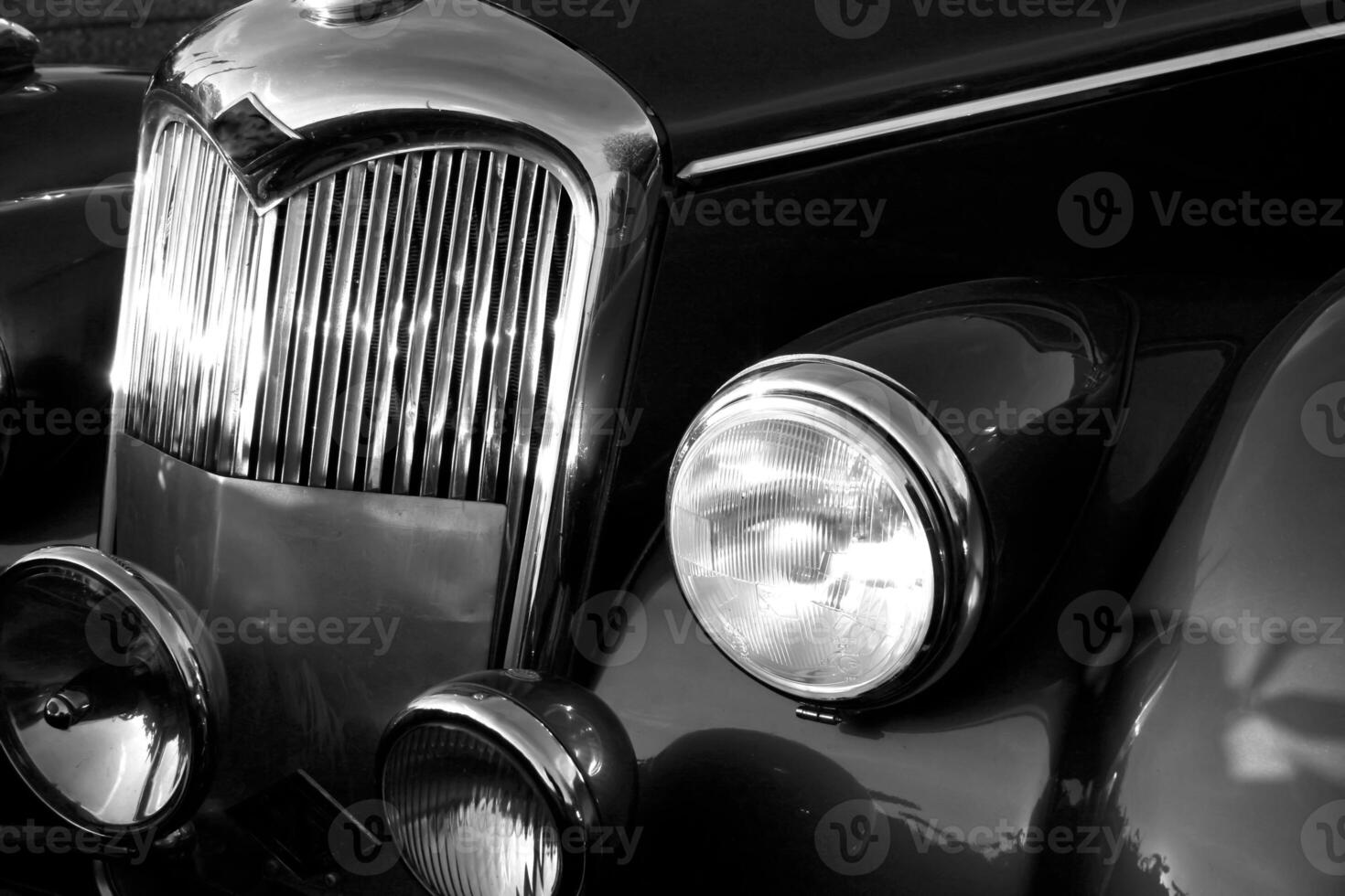 The front grill and headlight of the old beautiful car on the background copy space, card background photo