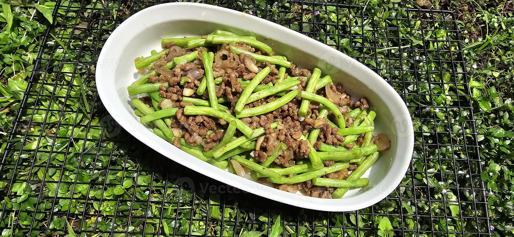 String green bean or french beans with minced beef stir fry or sauteed called Tumis buncis daging sapi cincang in Indonesia photo