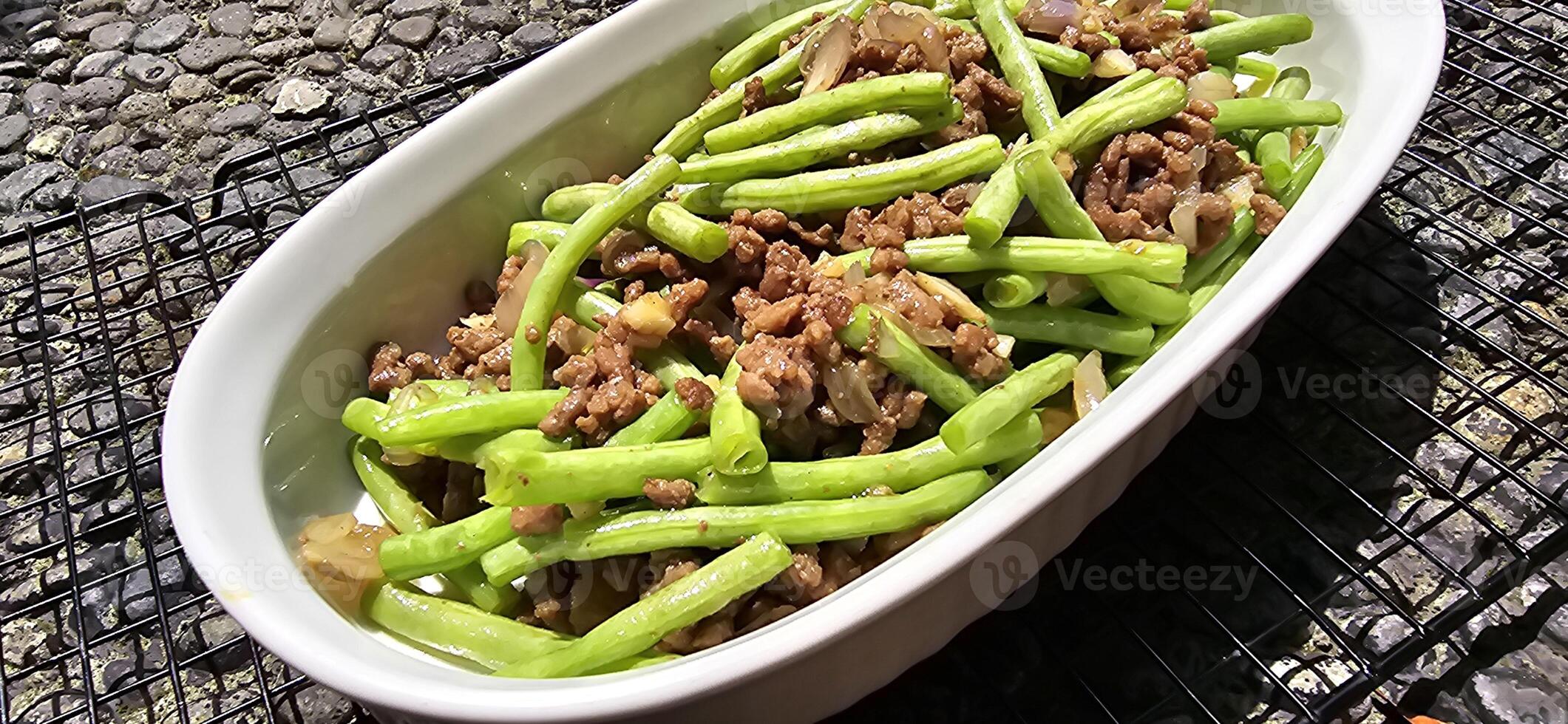 String green bean or french beans with minced beef stir fry or sauteed called Tumis buncis daging sapi cincang in Indonesia photo