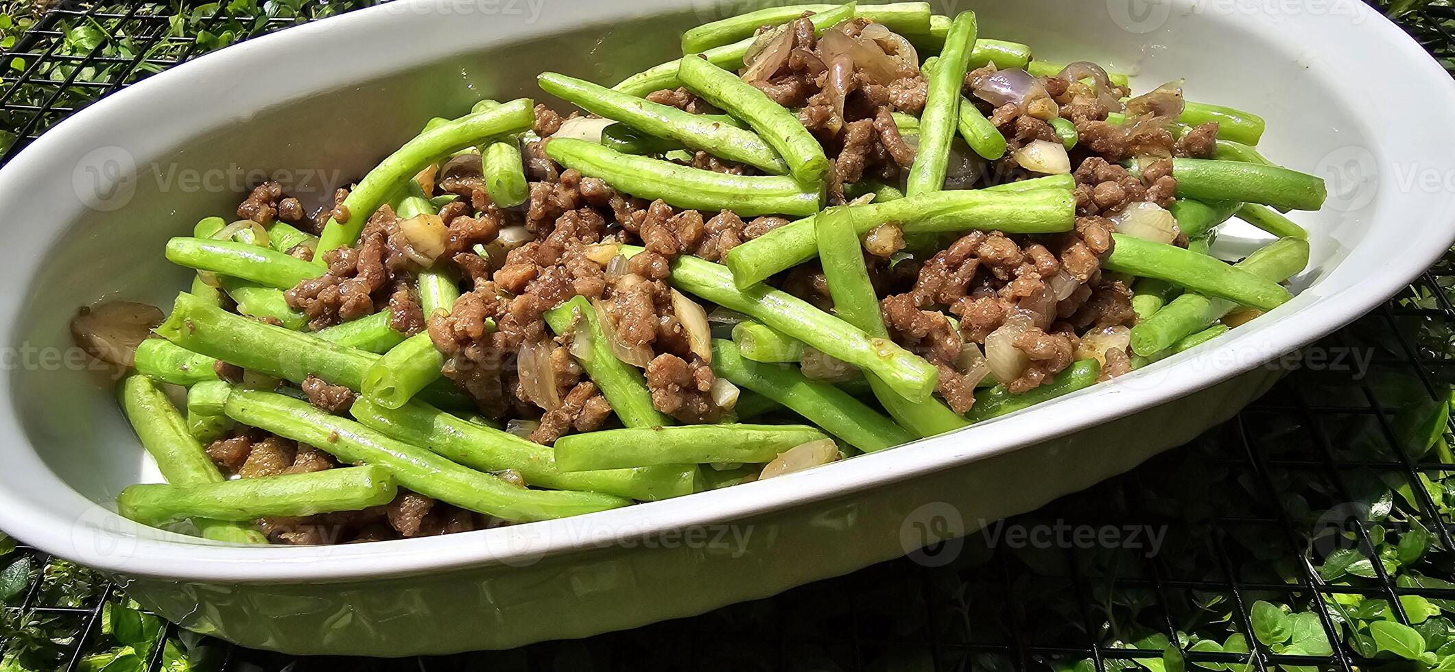 String green bean or french beans with minced beef stir fry or sauteed called Tumis buncis daging sapi cincang in Indonesia photo