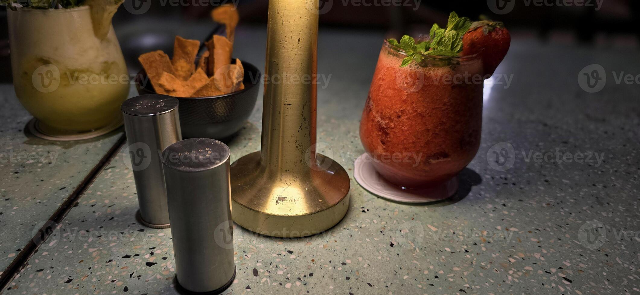 Fruit cocktail smoothie diet detox, tropical fruit summer cocktail with garnish, and ice on restaurant background photo