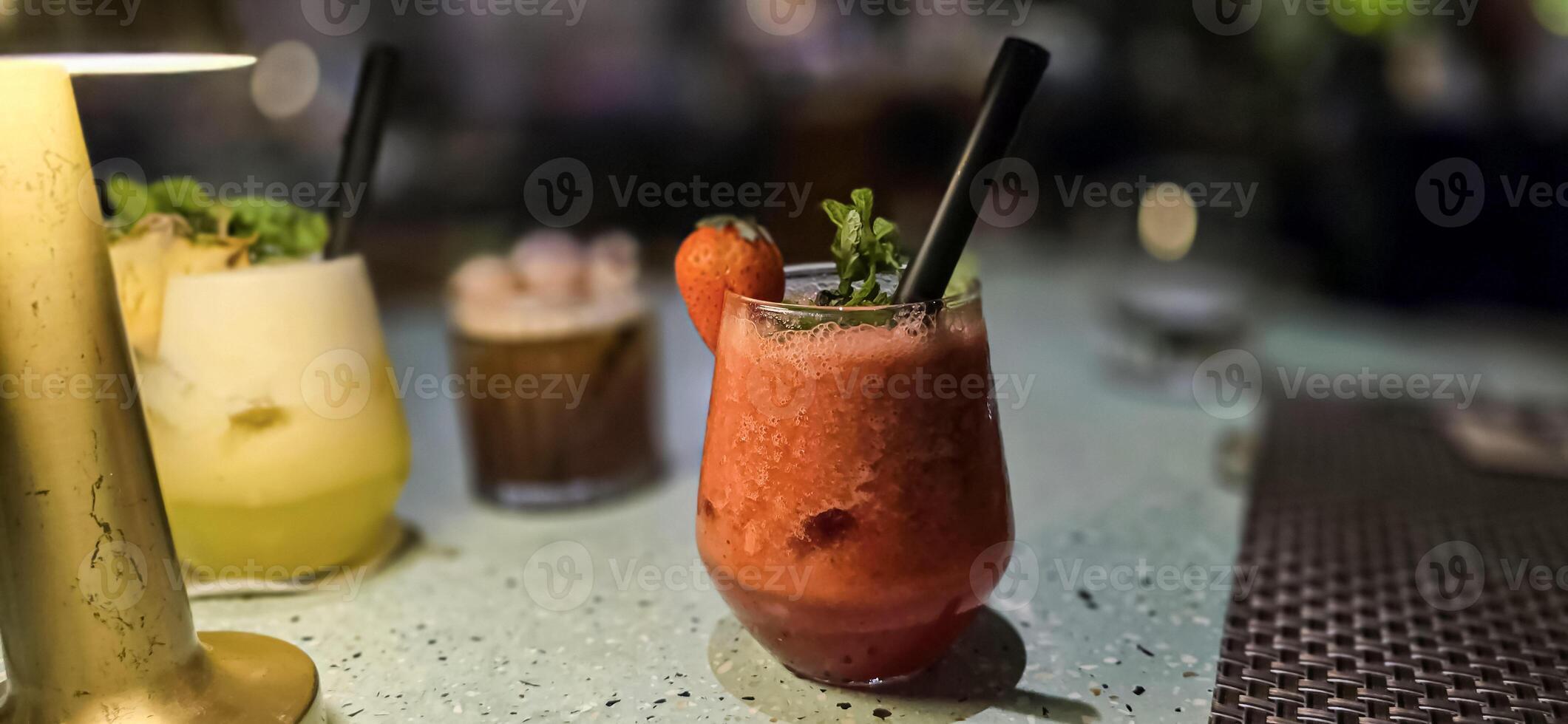 Fruit cocktail smoothie diet detox, tropical fruit summer cocktail with garnish, and ice on restaurant background photo