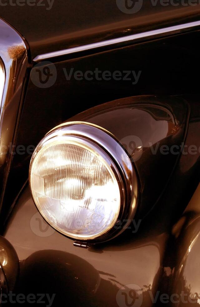 The front grill and headlight of the old beautiful car on the background copy space, card background photo