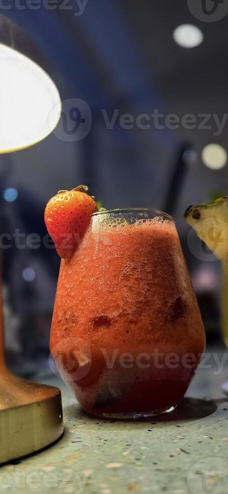 Fruit cocktail smoothie diet detox, tropical fruit summer cocktail with garnish, and ice on restaurant background photo
