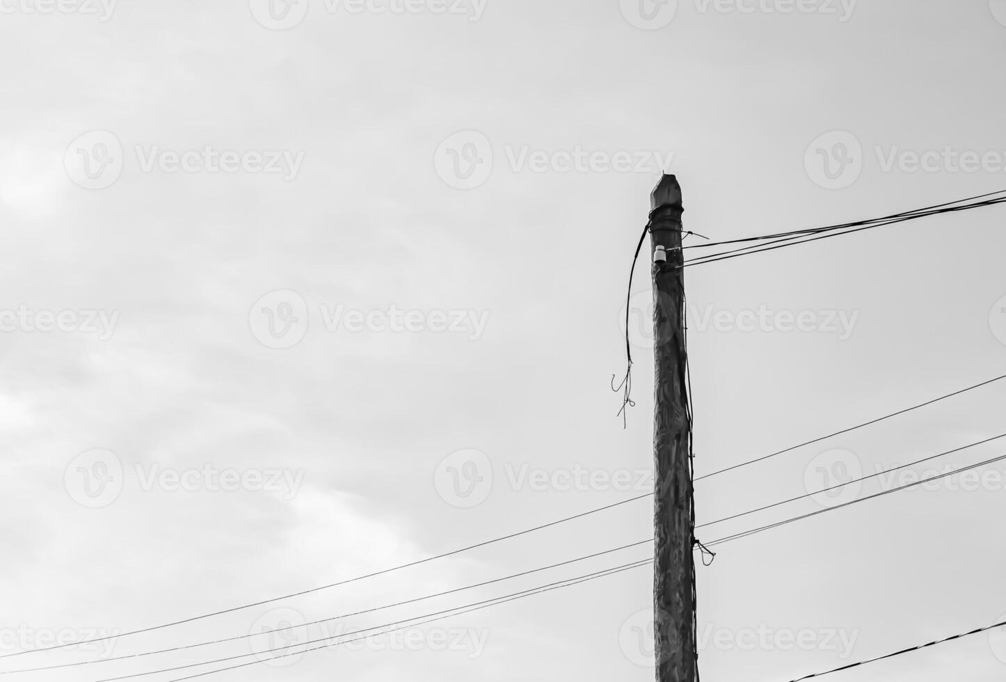 Power electric pole with line wire on light background close up photo