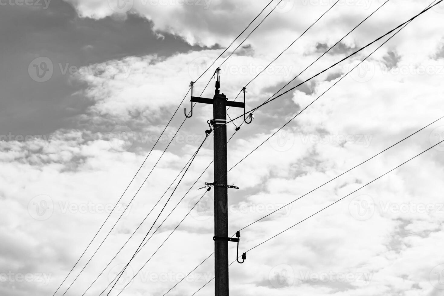 Power electric pole with line wire on dark background close up photo