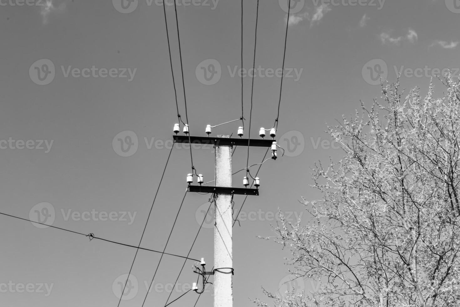 Power electric pole with line wire on light background close up photo