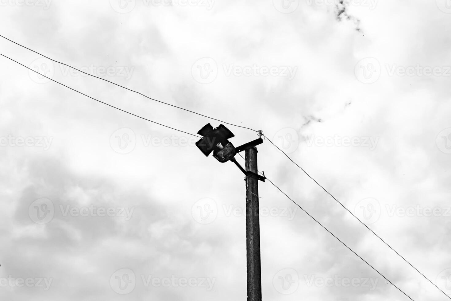 Power electric pole with line wire on dark background close up photo
