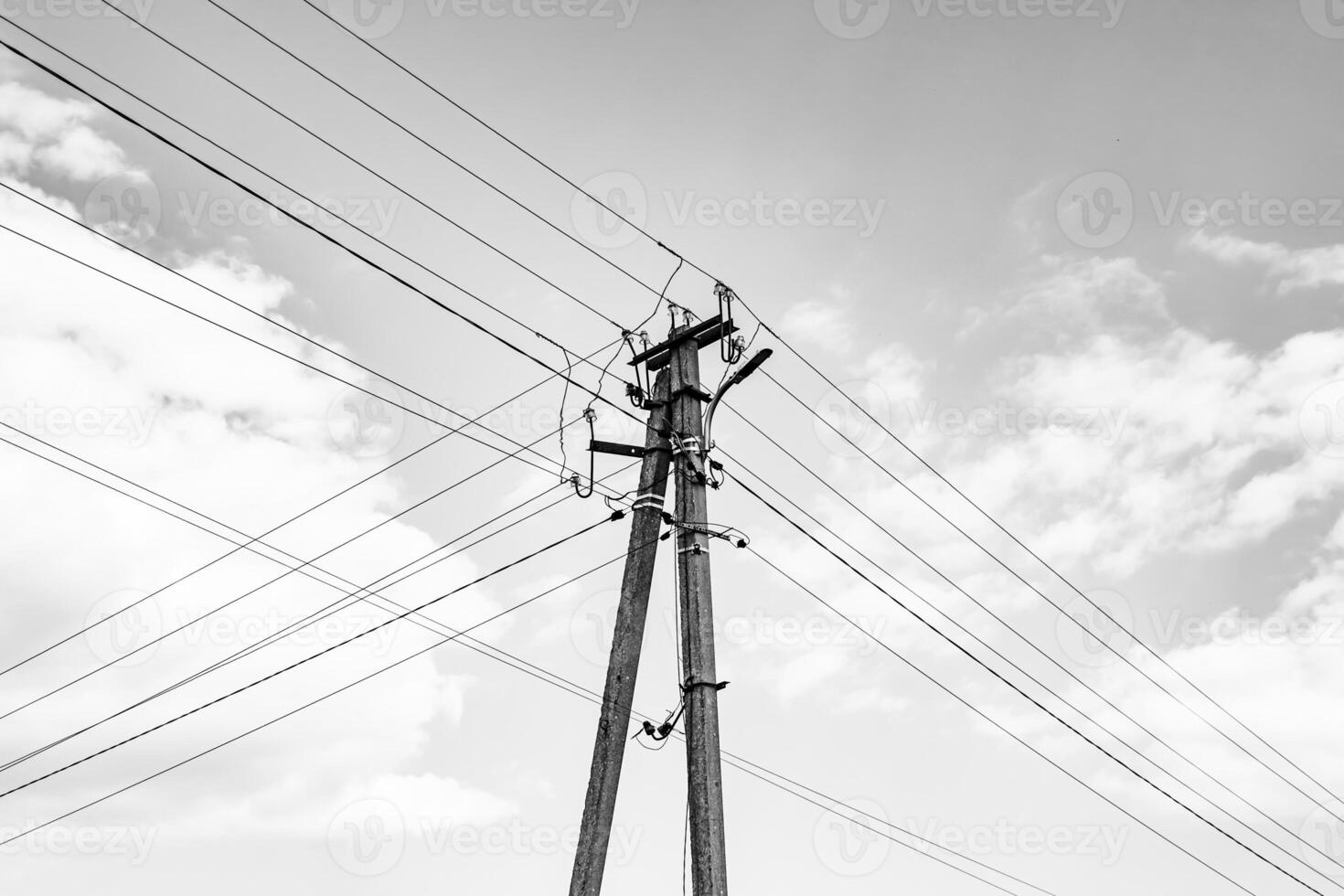 Power electric pole with line wire on dark background close up photo