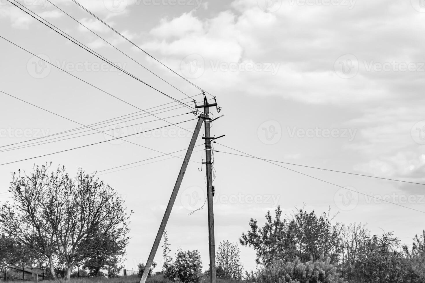 Power electric pole with line wire on dark background close up photo