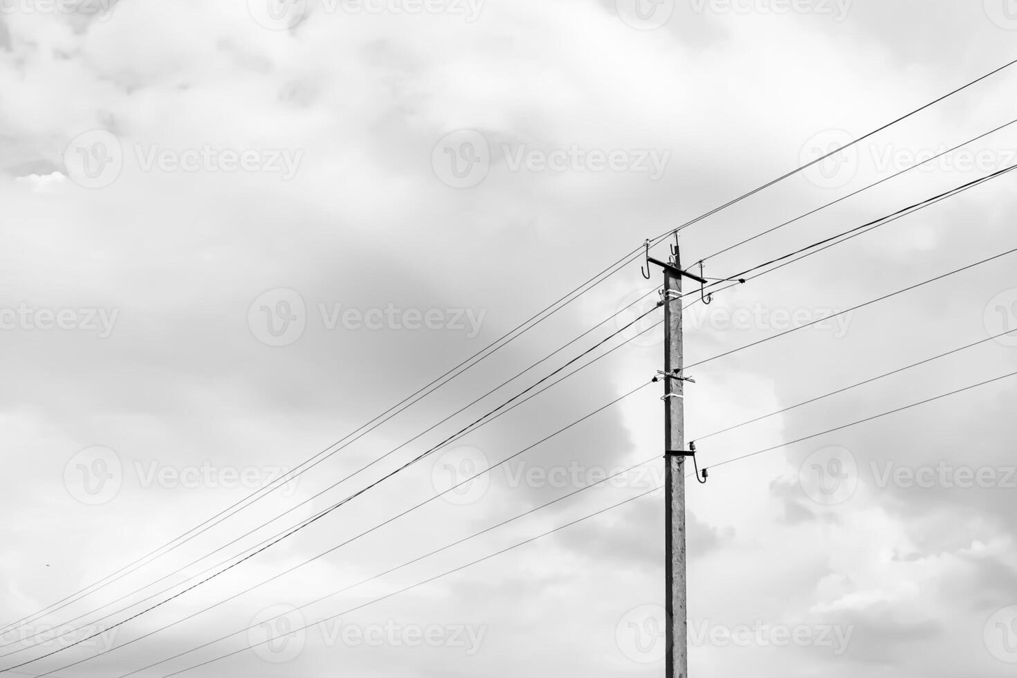 Power electric pole with line wire on light background close up photo