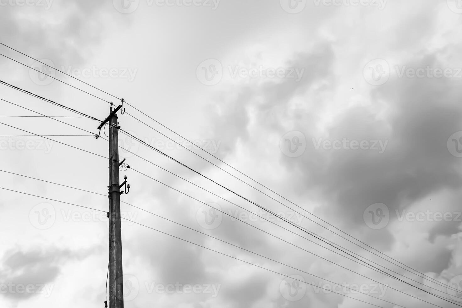 Power electric pole with line wire on light background close up photo