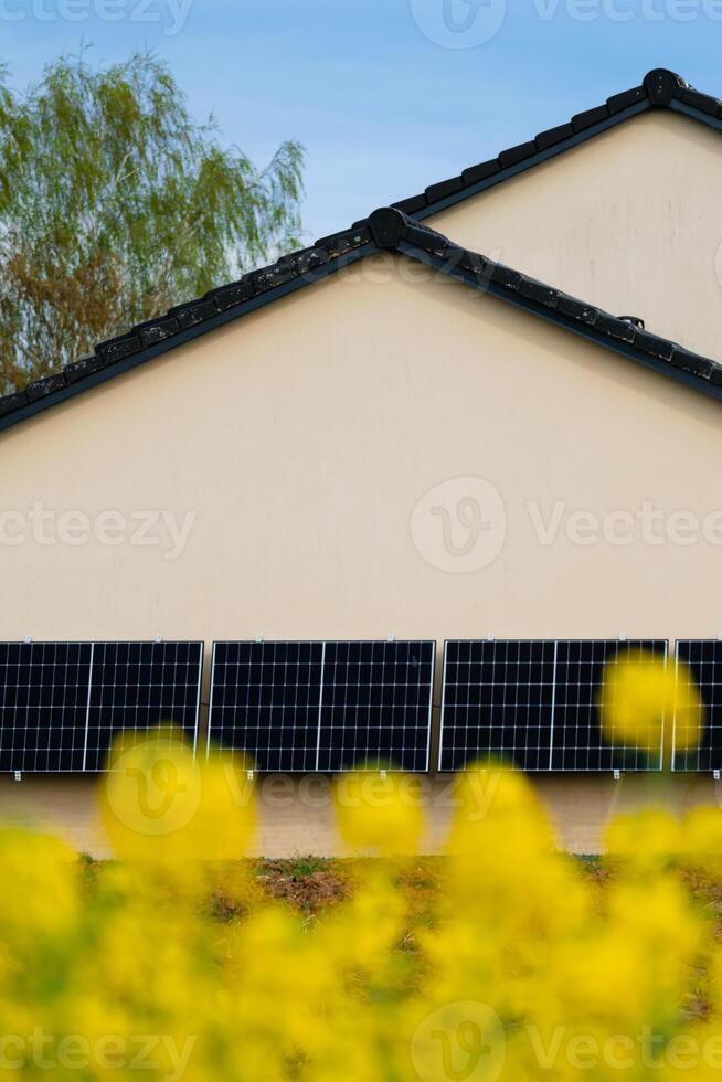 Solar panels on a well-exposed wall of an individual house, making savings following the energy crisis, eco-citizen gesture, green energy photo