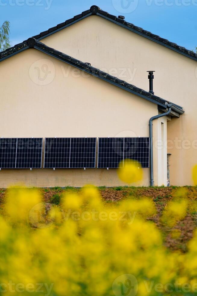 Solar panels on a well-exposed wall of an individual house, making savings following the energy crisis, eco-citizen gesture, green energy photo