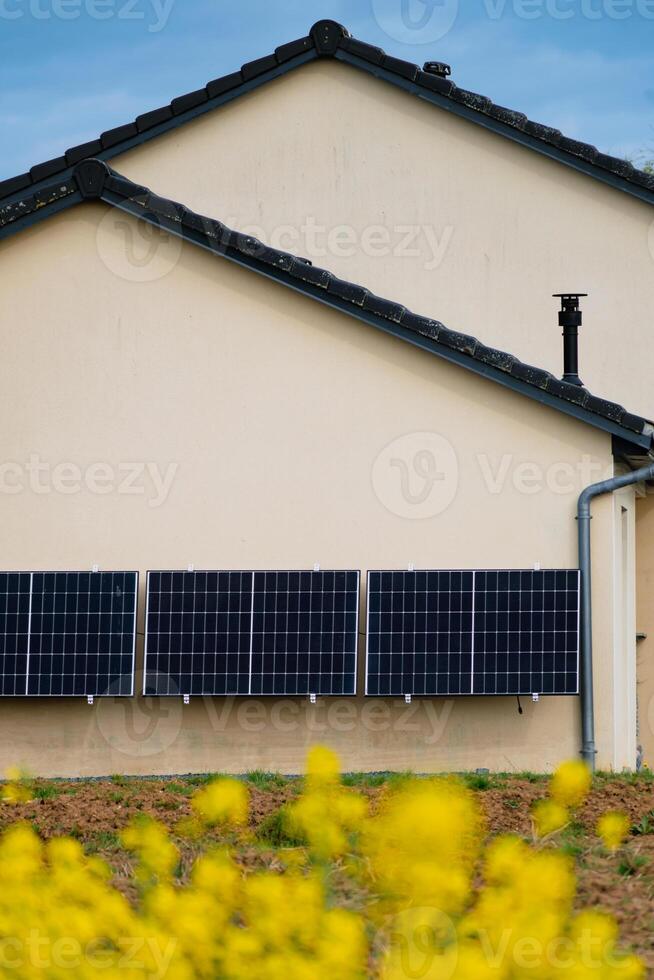 Solar panels on a well-exposed wall of an individual house, making savings following the energy crisis, eco-citizen gesture, green energy photo