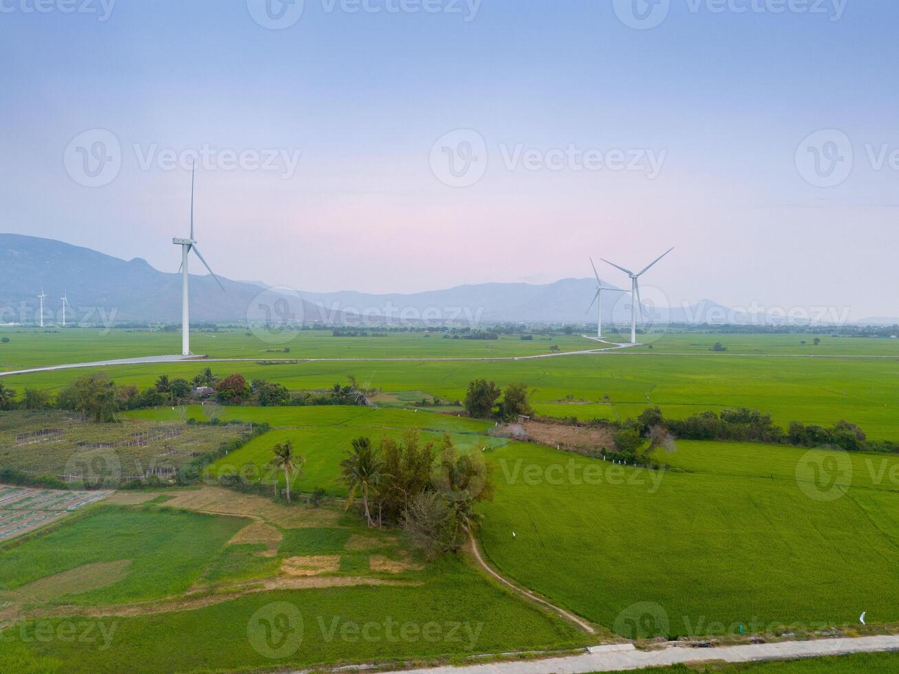 view of turbine green energy electricity, windmill for electric power production, Wind turbines generating electricity on rice field at Phan Rang, Ninh Thuan province, Vietnam photo