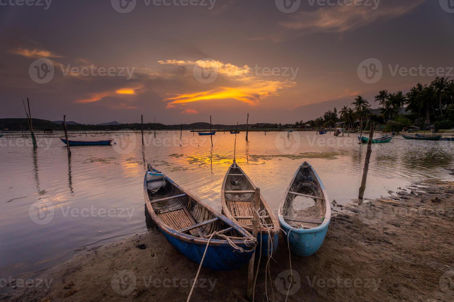 Traditional boats at O Loan lagoon in sunset, Phu Yen province, Vietnam photo